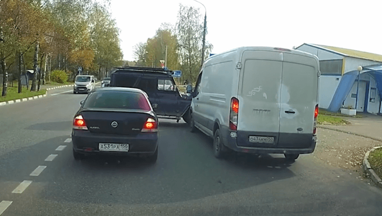 Car cutting through traffic poses risk to unseen oncoming vehicles