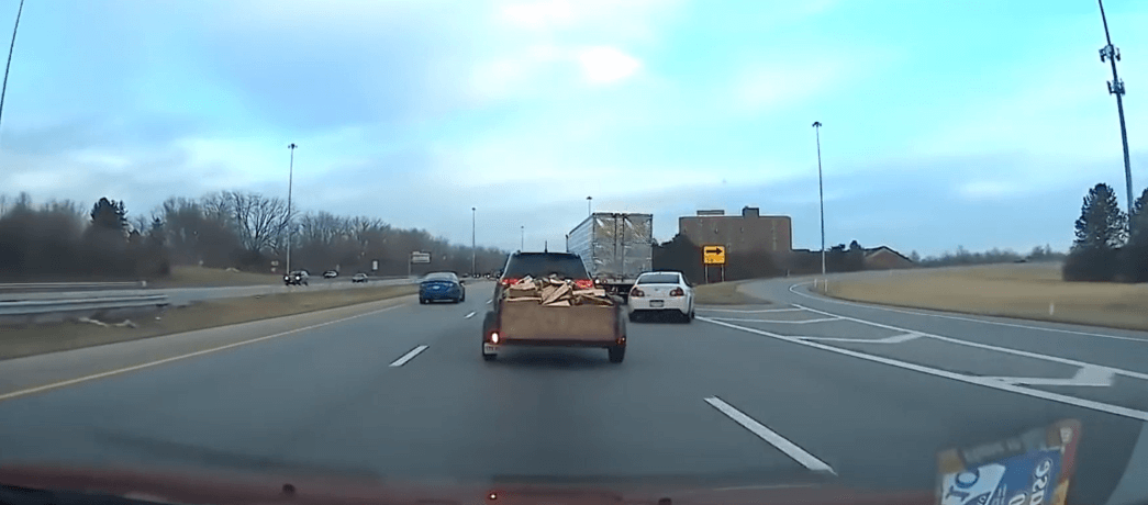 Vehicles approach highway fork with potential merging danger and unclear lane choices