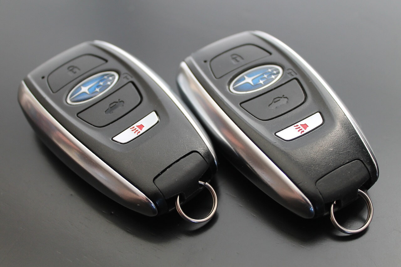Checking surroundings and using key fob safely before opening car doors to avoid hazards and theft